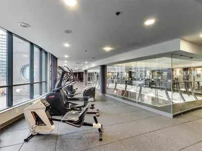 a gym with cardio equipment in a building at Downtown Toronto Condo Parking Sleeps 4 Balcony Walk to Lake in Toronto
