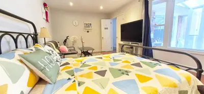 a bedroom with a bed with a colorful comforter at Toronto Spacious Cozy Mainfloor Room in Toronto