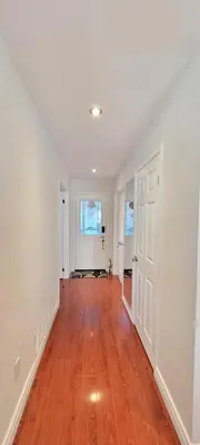an empty living room with white walls and wood floors at Toronto Spacious Cozy Mainfloor Room in Toronto