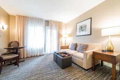 a hotel room with a couch and a table at Horseshoe Valley Suites - The Maple in Shanty Bay