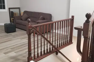 a living room with a couch and a staircase at Cozy Luxurious Detached 4 Bedroom House in Guelph
