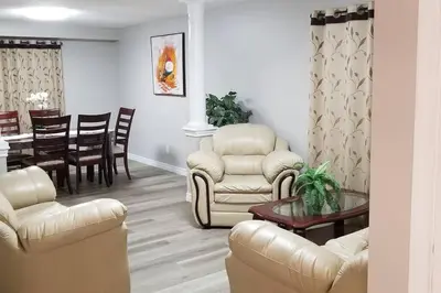 a living room with chairs and a dining room at Cozy Luxurious Detached 4 Bedroom House in Guelph