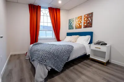 a bedroom with a bed and a window at Victoria's Lookout in London