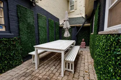 a white bench sitting next to a building with an umbrella at Victoria's Lookout in London