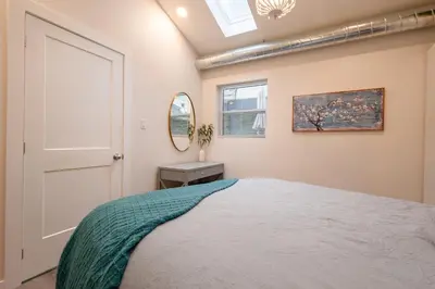 a bedroom with a bed and a window at Victoria's Lookout in London