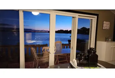 a living room with a view of the water at West Lake Waterfront Swimming - Free Pontoon Boat! in West Lake