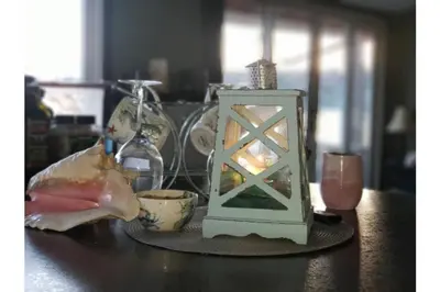 a table with a candle and a bottle on it at West Lake Waterfront Swimming - Free Pontoon Boat! in West Lake