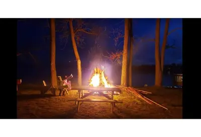 a fire pit in a park at night at West Lake Waterfront Swimming - Free Pontoon Boat! in West Lake