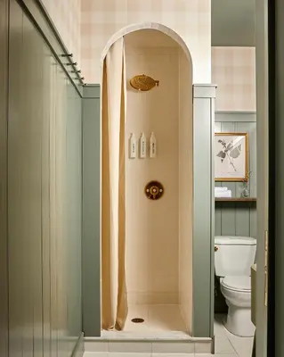 a bathroom with a shower and a toilet at The June Motel, Beaver Valley in Kimberley