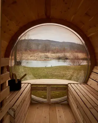 a window in a cabin with a view of a lake at The June Motel, Beaver Valley in Kimberley
