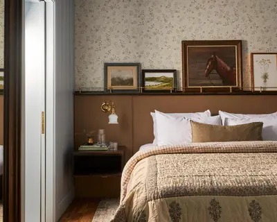 a bedroom with a bed with a horse picture on the wall at The June Motel, Beaver Valley in Kimberley