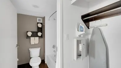a white bathroom with a toilet and a sink at Hampton Inn & Suites by Hilton Toronto Markham in Markham