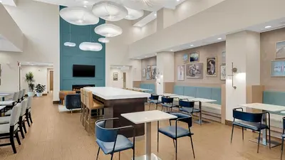 a restaurant with tables and chairs and a bar at Hampton Inn & Suites by Hilton Toronto Markham in Markham