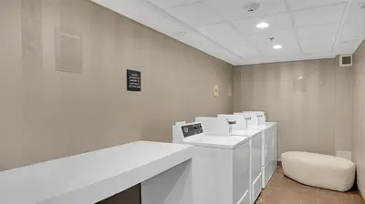 a waiting room with a white desk and a chair at Hampton Inn & Suites by Hilton Toronto Markham in Markham