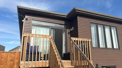 a tiny house with a large glass door at Beatrice Beach House in Wasaga Beach