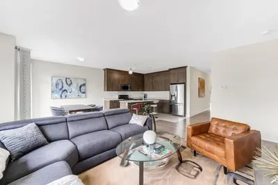 a living room with a couch and a table at Beatrice Beach House in Wasaga Beach
