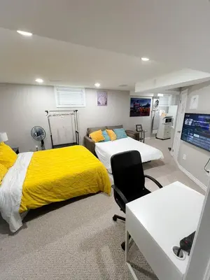 a bedroom with two beds and a yellow blanket at Amazing cozy fully private studio in London
