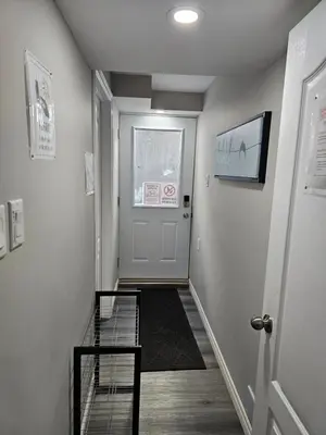 a hallway with a staircase and a door with a window at Amazing cozy fully private studio in London