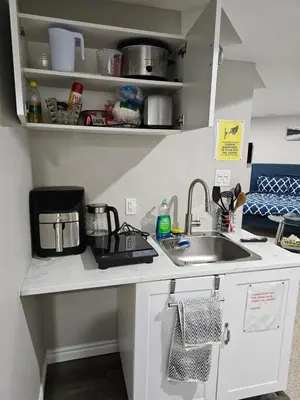 a kitchen counter with a sink and a coffee maker at Amazing cozy fully private studio in London