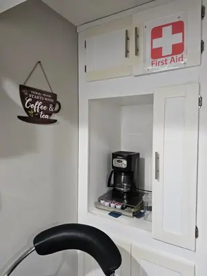 a kitchen with a cupboard with a coffee maker in it at Amazing cozy fully private studio in London