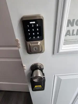 a door opener with an apple watch on the door at Amazing cozy fully private studio in London