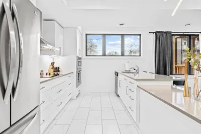 a white kitchen with white appliances and a window at Rent 8Bed 8Bath DowntownLondon Parking Wi-Fi in London