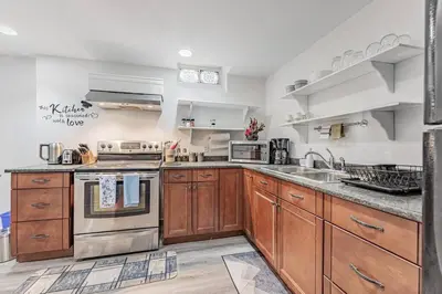 a kitchen with wooden cabinets and stainless steel appliances at Cozy Haven Retreat 2Bed Basement in Whitby