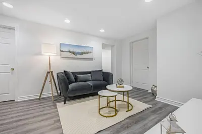 a living room with a couch and a table at Cozy Haven Retreat 2Bed Basement in Whitby