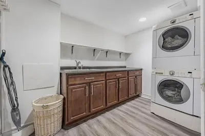 a kitchen with a sink and a washing machine at Cozy Haven Retreat 2Bed Basement in Whitby