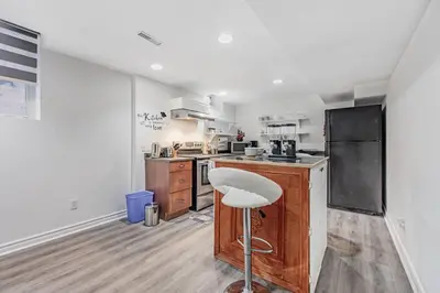 a kitchen with a counter and a stool in it at Cozy Haven Retreat 2Bed Basement in Whitby