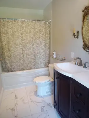 a bathroom with a sink and a toilet and a tub at Waterfront Hideaway Private Suite-King bed room in Tottenham
