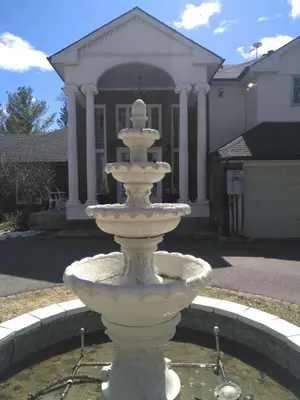 a white fountain in front of a house at Waterfront Hideaway Private Suite-King bed room in Tottenham