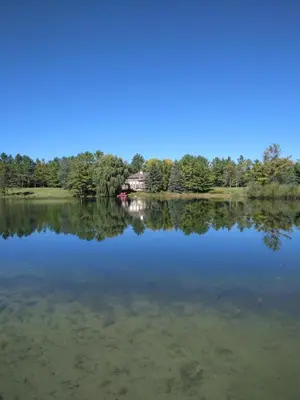 a view of a lake with a house in the distance at Waterfront Hideaway Private Suite-King bed room in Tottenham