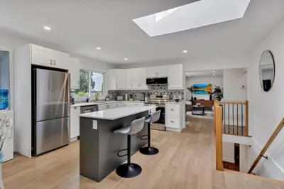 a large kitchen with white cabinets and a counter top at Dorado at The Kabins by The Falls in Fenelon Falls