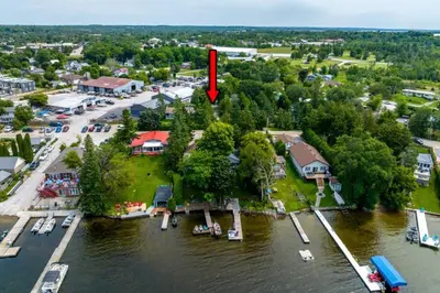 an island in the middle of a river with a red arrow at Dorado at The Kabins by The Falls in Fenelon Falls