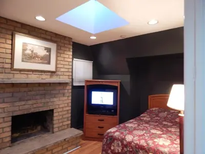 a bedroom with a fireplace and a tv and a bed at Nox Hostel in Toronto