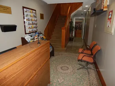 a waiting room with three chairs and a staircase at Nox Hostel in Toronto