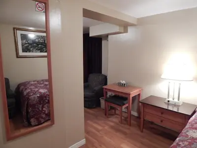 a room with a bed and a table and a mirror at Nox Hostel in Toronto