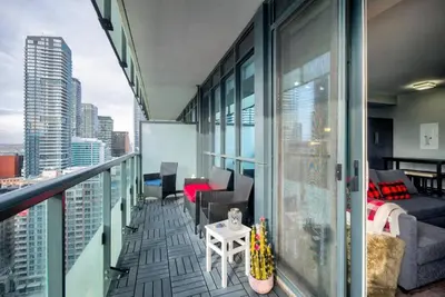 a balcony with a couch and a bed on a building at CN lovers in Toronto