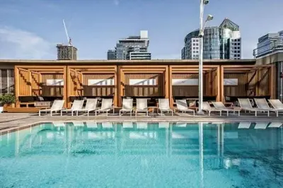 a swimming pool with chairs and a building at CN lovers in Toronto