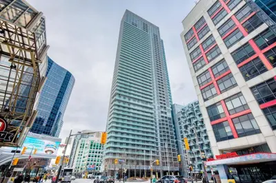 a city with tall buildings and a street with cars at CN lovers in Toronto