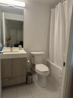 a bathroom with a toilet and a sink and a tub at Cozy holiday home in Toronto