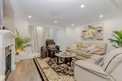 a living room with a couch and a fireplace at Luxury Basement Apartment in Oakville Monthly stays only in Oakville