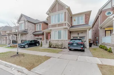 a car parked in front of a house at Luxury Basement Apartment in Oakville Monthly stays only in Oakville