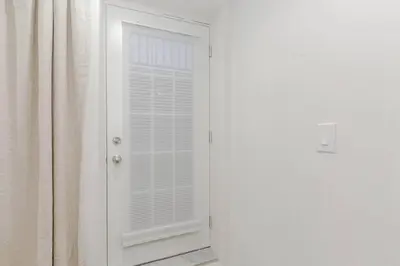 a white door with a window and a curtain at Luxury Basement Apartment in Oakville Monthly stays only in Oakville