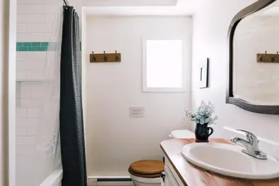 a bathroom with a sink and a toilet and a mirror at County Escape on Corey in Bloomfield