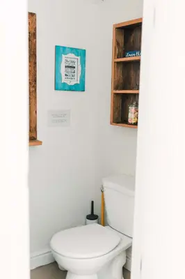 a bathroom with a toilet and a picture on the wall at County Escape on Corey in Bloomfield