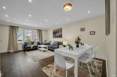 a living room with a white table and chairs at Luxury Renovated House in Prime Location with Parking in Toronto