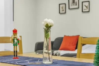 a vase with a white flower sitting on a table at Luxury Renovated House in Prime Location with Parking in Toronto