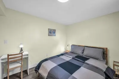 a bedroom with a bed and a desk and a chair at Luxury Renovated House in Prime Location with Parking in Toronto